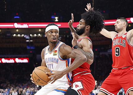 Nov 22, 2023; Oklahoma City, Oklahoma, USA; Oklahoma City Thunder guard Shai Gilgeous-Alexander (2) is defended by Chicago Bulls guard Coby White (0) on a drive to the basket during the second quarter at Paycom Center. Mandatory Credit: Alonzo Adams-USA TODAY Sports