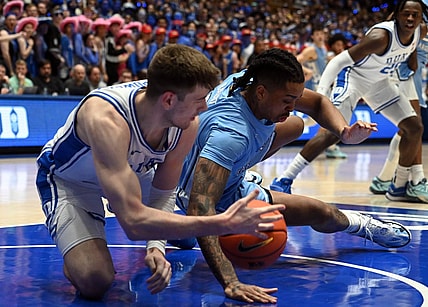 Mar 9, 2024; Durham, North Carolina, USA; North Carolina Tar Heels forward Armando Bacot (5) grabs a loose ball from Duke Blue Devils center Kyle Filipowski (30) during the first half at Cameron Indoor Stadium. Mandatory Credit: Rob Kinnan-USA TODAY Sports