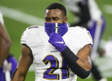 Dec 14, 2020; Cleveland, Ohio, USA; Baltimore Ravens running back Mark Ingram (21) adjusts his face mask before the game against the Cleveland Browns at FirstEnergy Stadium. Mandatory Credit: Scott Galvin-USA TODAY Sports