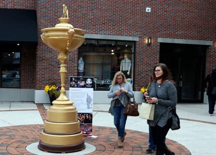 Women walk by a large replica of the Ryder Cup trophy at Kohler Food and Wine, Friday, October 19, 2018, in Kohler, Wis. The Ryder Cup will be at Whistling Straits in 2020

101918 She Kohler Food And Wine Gck 12