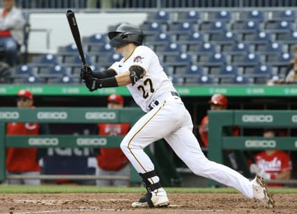 Sep 28, 2022; Pittsburgh, Pennsylvania, USA;  Pittsburgh Pirates second baseman Kevin Newman (27) hits a game winning single to defeat the Cincinnati Reds in ten innings at PNC Park. The Pirates won 4-3 in ten innings.  Mandatory Credit: Charles LeClaire-USA TODAY Sports