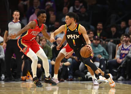 Dec 17, 2022; Phoenix, Arizona, USA; Phoenix Suns guard Devin Booker (1) against New Orleans Pelicans forward Herbert Jones in the first half at Footprint Center. Mandatory Credit: Mark J. Rebilas-USA TODAY Sports