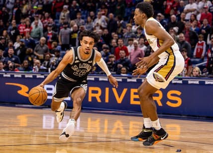 Dec 22, 2022; New Orleans, Louisiana, USA; San Antonio Spurs guard Tre Jones (33) drives to the basket against New Orleans Pelicans forward Herbert Jones (5) during the first half at Smoothie King Center. Mandatory Credit: Stephen Lew-USA TODAY Sports
