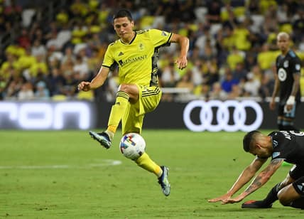 Aug 14, 2022; Nashville, Tennessee, USA; Nashville SC defender Eric Miller (15) kicks the ball against the Minnesota United FC during the second half at Geodis Park. Mandatory Credit: Steve Roberts-USA TODAY Sports