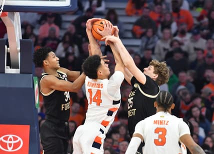 Mar 4, 2023; Syracuse, New York, USA; Syracuse Orange center Jesse Edwards (14) battles Wake Forest Demon Deacons forward Bobi Klintman (34) and forward Zach Keller (25) for a rebound in the second half at JMA Wireless Dome. Mandatory Credit: Mark Konezny-USA TODAY Sports