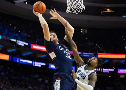Jan 20, 2024; Philadelphia, Pennsylvania, USA; Connecticut Huskies center Donovan Clingan (32) drives for a shot against Villanova Wildcats forward Jordann Dumont (10) during the first half at Wells Fargo Center. Mandatory Credit: Bill Streicher-USA TODAY Sports