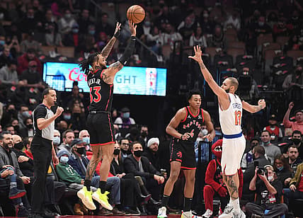Dec 10, 2021; Toronto, Ontario, CAN;  Toronto Raptors guard Gary Trent Jr. (33) shoots the ball against New York Knicks guard Evan Fournier (13) in the first half at Scotiabank Arena. Mandatory Credit: Dan Hamilton-USA TODAY Sports