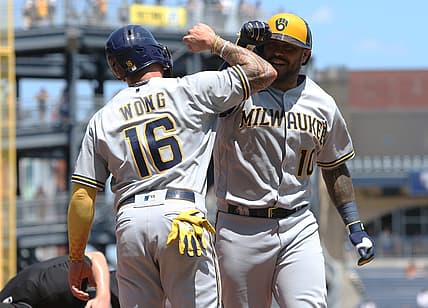 Jul 3, 2022; Pittsburgh, Pennsylvania, USA;  Milwaukee Brewers second baseman Kolten Wong (16) celebrates with catcher Omar Narvaez (10) as he crosses home plate on a two-run home run against the Pittsburgh Pirates during the fifth inning at PNC Park. Mandatory Credit: Charles LeClaire-USA TODAY Sports