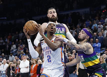 Feb 13, 2023; Oklahoma City, Oklahoma, USA; Oklahoma City Thunder guard Shai Gilgeous-Alexander (2) is defended by New Orleans Pelicans forward Herbert Jones (5) on a drive to the basket during the first quarter at Paycom Center. Mandatory Credit: Alonzo Adams-USA TODAY Sports