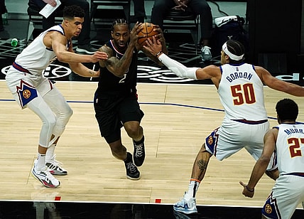 Apr 1, 2021; Los Angeles, California, USA; Los Angeles Clippers forward Kawhi Leonard (2) moves the ball against Denver Nuggets forward Will Barton (5) and forward Aaron Gordon (50) during the first half at Staples Center. Mandatory Credit: Gary A. Vasquez-USA TODAY Sports