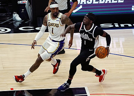 Apr 4, 2021; Los Angeles, California, USA; Los Angeles Clippers guard Reggie Jackson (1) moves to the basket against Los Angeles Lakers guard Kentavious Caldwell-Pope (1) during the first half at Staples Center. Mandatory Credit: Gary A. Vasquez-USA TODAY Sports