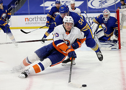 May 3, 2021; Buffalo, New York, USA; Buffalo Sabres defenseman Mattias Samuelsson (54) knocks down New York Islanders center Mathew Barzal (13) as he skates with the puck during the first period at KeyBank Center. Mandatory Credit: Timothy T. Ludwig-USA TODAY Sports