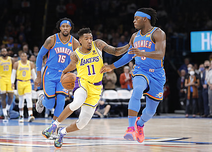 Oct 27, 2021; Oklahoma City, Oklahoma, USA; Los Angeles Lakers guard Malik Monk (11) drives down the court as Oklahoma City Thunder forward Luguentz Dort (5) defends during the first quarter at Paycom Center. Mandatory Credit: Alonzo Adams-USA TODAY Sports