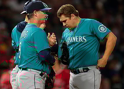 Sep 25, 2021; Anaheim, California, USA; Seattle Mariners manager Scott Servais (9) talks to relief pitcher Erik Swanson (50) during in the fifth inning against the Los Angeles Angels at Angel Stadium. Mandatory Credit: Robert Hanashiro-USA TODAY Sports