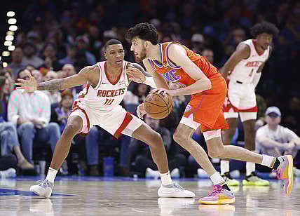 Feb 27, 2024; Oklahoma City, Oklahoma, USA; Oklahoma City Thunder forward Chet Holmgren (7) moves the ball as Houston Rockets forward Jabari Smith Jr. (10) defends during the second half at Paycom Center. Mandatory Credit: Alonzo Adams-USA TODAY Sports