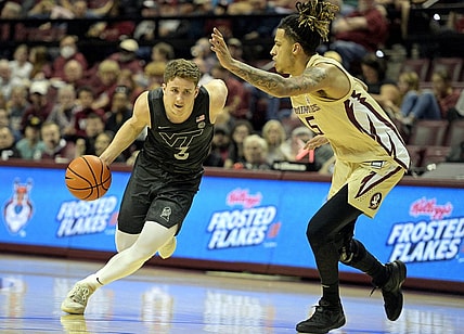 Jan 6, 2024; Tallahassee, Florida, USA; Virginia Tech Hokies guard Sean Pedulla (3) drives past Florida State Seminoles forward De Ante Green (5) during the first half at Donald L. Tucker Center. Mandatory Credit: Melina Myers-USA TODAY Sports