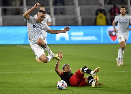 May 13, 2021; Washington, DC, Washington, DC, USA; Chicago Fire defender Boris Sekulic (2) leaps over D.C. United defender Tony Alfaro (93) during the first half at Audi Field. Mandatory Credit: Brad Mills-USA TODAY Sports