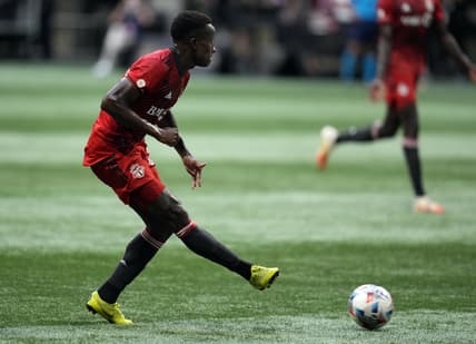 Aug 18, 2021; Atlanta, Georgia, USA; Toronto FC midfielder Richie Laryea (22) kicks the ball against the Atlanta United  during the first half at Mercedes-Benz Stadium. Mandatory Credit: Dale Zanine-USA TODAY Sports