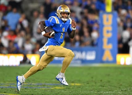 Sep 30, 2022; Pasadena, California, USA; UCLA Bruins quarterback Dorian Thompson-Robinson (1) runs for a 4 yard gain in the first half against the Washington Huskies at the Rose Bowl. Mandatory Credit: Jayne Kamin-Oncea-USA TODAY Sports