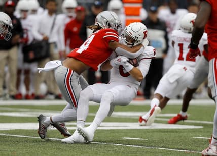 Oct 1, 2022; Columbus, Ohio, USA;  Ohio State Buckeyes safety Ronnie Hickman (14) tackles Rutgers Scarlet Knights quarterback Noah Vedral (0) for a loss during the first quarter at Ohio Stadium. Mandatory Credit: Joseph Maiorana-USA TODAY Sports