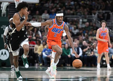 Nov 5, 2022; Milwaukee, Wisconsin, USA; Oklahoma City Thunder guard Shai Gilgeous-Alexander (2) pushes the ball up the court against Milwaukee Bucks guard MarJon Beauchamp (0) in the third quarter at Fiserv Forum. Mandatory Credit: Michael McLoone-USA TODAY Sports
