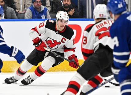 Nov 17, 2022; Toronto, Ontario, CAN; New Jersey Devils forward Nico Hischier (13) skates with the puck against the Toronto Maple Leaf in the third period at Scotiabank Arena. Mandatory Credit: Dan Hamilton-USA TODAY Sports