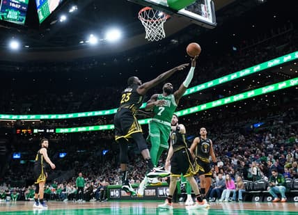 Jan 19, 2023; Boston, Massachusetts, USA; Boston Celtics guard Jaylen Brown (7) shoots against Golden State Warriors forward Draymond Green (23) in the second half at TD Garden. Mandatory Credit: David Butler II-USA TODAY Sports