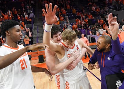 January 21, 2023; Clemson, SC; Clemson sophomore forward PJ Hall (24) hugs forward Hunter Tyson (5) near freshman forward Chauncey Wiggins (21) after the Tigers beat Virginia Tech at Littlejohn Coliseum in Clemson, S.C. Saturday, January 21, 2023. Hunter made the go-ahead three-point shot and rebound in the end helping the Tigers win 51-50. Hall led the Tigers with 20 points.  Mandatory Credit: Ken Ruinard-USA TODAY NETWORK