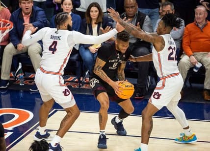 Texas A&M Aggies guard Dexter Dennis (0) looks to pass out of a trap as Auburn Tigers take on Texas A&M Aggies at Neville Arena in Auburn, Ala., on Wednesday, Jan. 25, 2023. Texas A&M Aggies defeated Auburn Tigers 79-63.