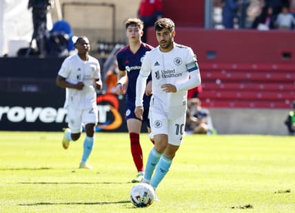 Oct 9, 2022; Chicago, Illinois, USA; New England Revolution midfielder Carles Gil (10) kicks the ball against the Chicago Fire during the first half at Bridgeview Stadium. Mandatory Credit: Mike Dinovo-USA TODAY Sports