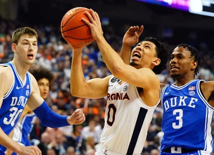 Mar 11, 2023; Greensboro, NC, USA; Virginia Cavaliers guard Kihei Clark (0) drives to the basket against Duke Blue Devils center Kyle Filipowski (30) and guard Jeremy Roach (3) during the first half of the ACC Championship at Greensboro Coliseum. Mandatory Credit: John David Mercer-USA TODAY Sports
