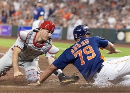 Apr 28, 2023; Houston, Texas, USA; Houston Astros first baseman Jose Abreu (79) is tagged out at home plate by Philadelphia Phillies catcher J.T. Realmuto (10) in the fifth inning at Minute Maid Park. Mandatory Credit: Thomas Shea-USA TODAY Sports