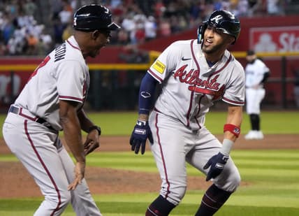 Jun 4, 2023; Phoenix, AZ, USA; Atlanta Braves' Eddie Rosario (8) celebrates his ninth inning grand slam with third base coach Ron Washington (37) against the Arizona Diamondbacks at Chase Field.  Mandatory Credit: Joseph Rondone-USA TODAY Sports