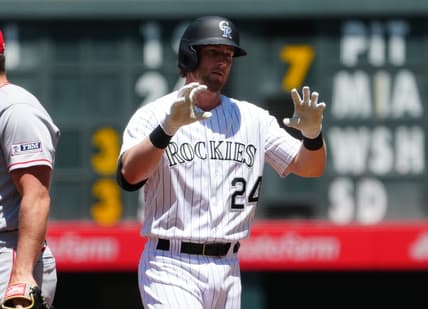 Jun 25, 2023; Denver, Colorado, USA; Colorado Rockies third baseman Ryan McMahon (24) reacts to his single in the first inning against the Los Angeles Angels at Coors Field. Mandatory Credit: Ron Chenoy-USA TODAY Sports
