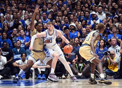 Jan 13, 2024; Durham, North Carolina, USA;  Duke Blue Devils center Kyle Filipowski (30) controls the ball against Georgia Tech Yellow Jackets foward Tyzhaun Claude (12)during the first half at Cameron Indoor Stadium. Mandatory Credit: Rob Kinnan-USA TODAY Sports