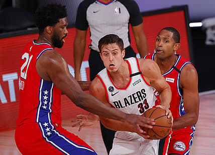 Aug 9, 2020; Lake Buena Vista, Florida, USA;  Zach Collins #33 of the Portland Trail Blazers is pressured by Joel Embiid #21 of the Philadelphia 76ers at Visa Athletic Center at ESPN Wide World Of Sports Complex on August 09, 2020 in Lake Buena Vista, Florida.  Mandatory Credit: Kevin C. Cox/Pool Photo-USA TODAY Sports