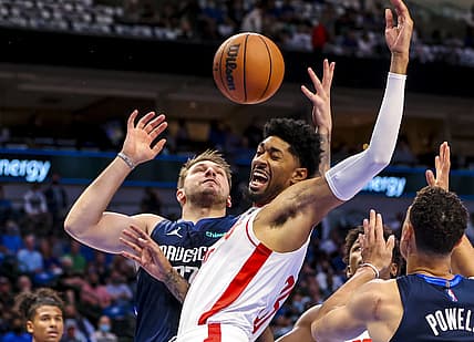 Oct 26, 2021; Dallas, Texas, USA;  Dallas Mavericks guard Luka Doncic (77) shoots as Houston Rockets center Christian Wood (35) defends during the first quarter at American Airlines Center. Mandatory Credit: Kevin Jairaj-USA TODAY Sports