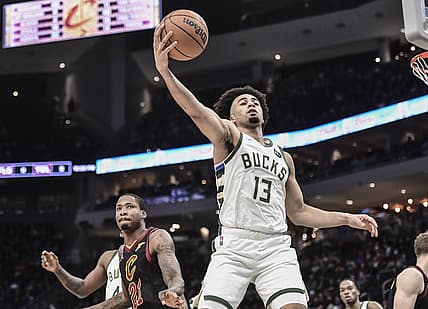 Dec 18, 2021; Milwaukee, Wisconsin, USA;  Milwaukee Bucks forward Jordan Nwora (13) rebounds the ball against Cleveland Cavaliers center Ed Davis (21) in the fourth quarter at Fiserv Forum. Mandatory Credit: Benny Sieu-USA TODAY Sports