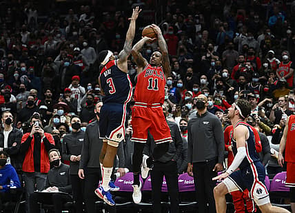 Jan 1, 2022; Washington, District of Columbia, USA; Chicago Bulls forward DeMar DeRozan (11) hits a game winning three point shot over Washington Wizards guard Bradley Beal (3) during the second half at Capital One Arena. Mandatory Credit: Brad Mills-USA TODAY Sports