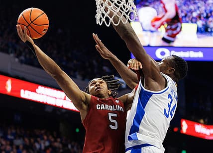 Jan 10, 2023; Lexington, Kentucky, USA; South Carolina Gamecocks guard Meechie Johnson (5) goes to the basket against Kentucky Wildcats forward Oscar Tshiebwe (34) during the first half at Rupp Arena at Central Bank Center. Mandatory Credit: Jordan Prather-USA TODAY Sports