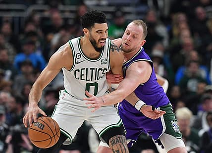 Mar 30, 2023; Milwaukee, Wisconsin, USA; Milwaukee Bucks guard Goran Dragic (7) reaches in on Milwaukee Bucks guard Boston Celtics forward Jayson Tatum (0) in the first half at Fiserv Forum. Mandatory Credit: Michael McLoone-USA TODAY Sports