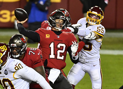 Jan 9, 2021; Landover, Maryland, USA; Tampa Bay Buccaneers quarterback Tom Brady (12) throws a pass as Washington Football Team linebacker Cole Holcomb (55) rushes during the third quarter at FedExField. Mandatory Credit: Brad Mills-USA TODAY Sports