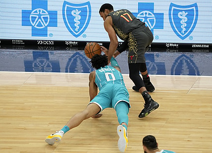 Apr 22, 2021; Chicago, Illinois, USA; Charlotte Hornets forward Miles Bridges (0) attempts to steal the ball from Chicago Bulls forward Garrett Temple (17) during the second quarter at the United Center. Mandatory Credit: Mike Dinovo-USA TODAY Sports
