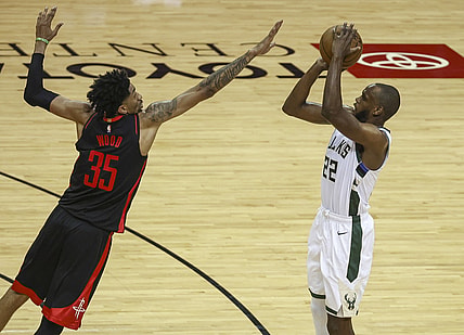 Apr 29, 2021; Houston, Texas, USA; Milwaukee Bucks forward Khris Middleton (22) shoots the ball as Houston Rockets center Christian Wood (35) defends during the third quarter at Toyota Center. Mandatory Credit: Troy Taormina-USA TODAY Sports