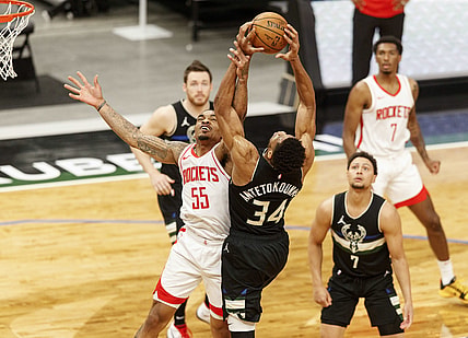 May 7, 2021; Milwaukee, Wisconsin, USA; Houston Rockets guard DaQuan Jeffries (55) and Milwaukee Bucks forward Giannis Antetokounmpo (34) reach for a rebound during the first quarter at Fiserv Forum. Mandatory Credit: Jeff Hanisch-USA TODAY Sports