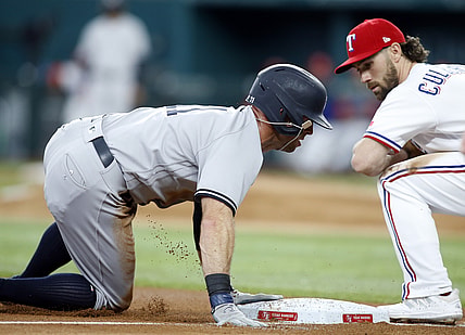 May 20, 2021; Arlington, Texas, USA; New York Yankees center fielder Brett Gardner (11) is safe at third base on a wild pitch as Texas Rangers third baseman Charlie Culberson (2) defends in the fourth inning at Globe Life Field. Mandatory Credit: Tim Heitman-USA TODAY Sports