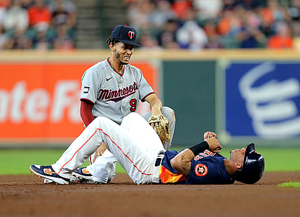 Aug 8, 2021; Houston, Texas, USA; Minnesota Twins shortstop Andrelton Simmons (9) and Houston Astros designated hitter Michael Brantley (23) react after a collision at second base during the first inning at Minute Maid Park. Mandatory Credit: Erik Williams-USA TODAY Sports