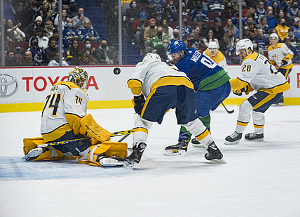 Nov 5, 2021; Vancouver, British Columbia, CAN; Nashville Predators goalie Juuse Saros (74) makes a save on Vancouver Canucks forward J.T. Miller (9) in the first period at Rogers Arena. Mandatory Credit: Bob Frid-USA TODAY Sports