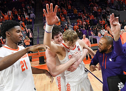 January 21, 2023; Clemson, SC; Clemson sophomore forward PJ Hall (24) hugs forward Hunter Tyson (5) near freshman forward Chauncey Wiggins (21) after the Tigers beat Virginia Tech at Littlejohn Coliseum in Clemson, S.C. Saturday, January 21, 2023. Hunter made the go-ahead three-point shot and rebound in the end helping the Tigers win 51-50. Hall led the Tigers with 20 points.  Mandatory Credit: Ken Ruinard-USA TODAY NETWORK