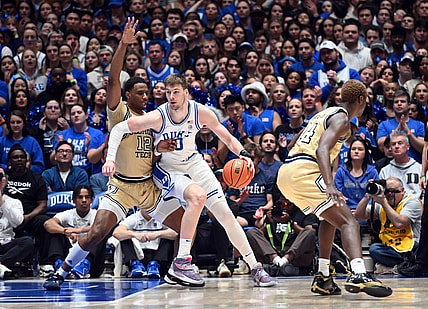 Jan 13, 2024; Durham, North Carolina, USA;  Duke Blue Devils center Kyle Filipowski (30) controls the ball against Georgia Tech Yellow Jackets foward Tyzhaun Claude (12)during the first half at Cameron Indoor Stadium. Mandatory Credit: Rob Kinnan-USA TODAY Sports